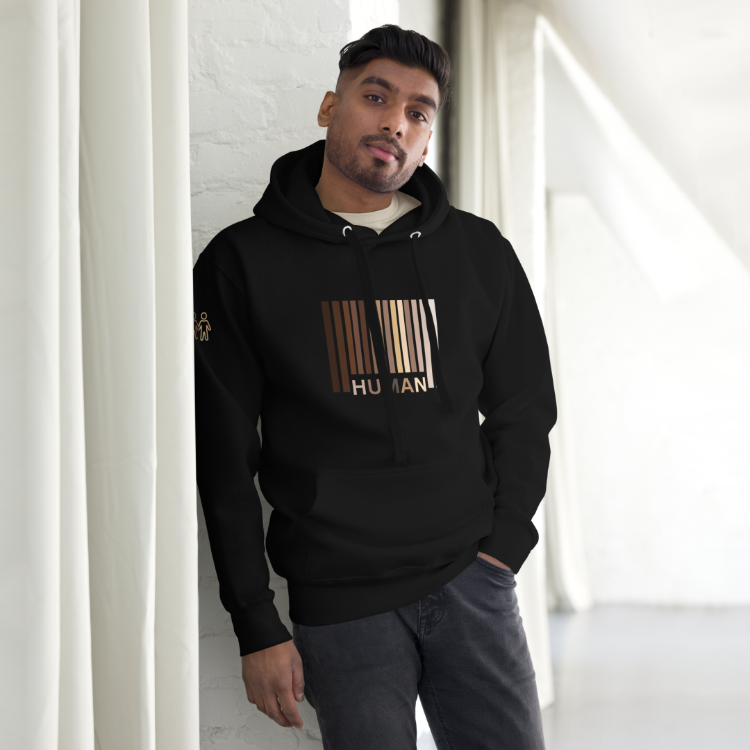 Man leaning against the wall wearing a black Eli Nelly Human Hoodie