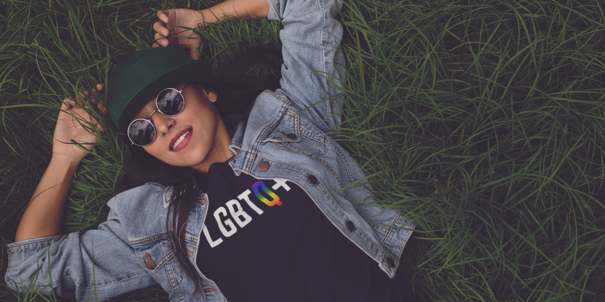Woman Lying on ground wearing LGBTQ+ T-shirt